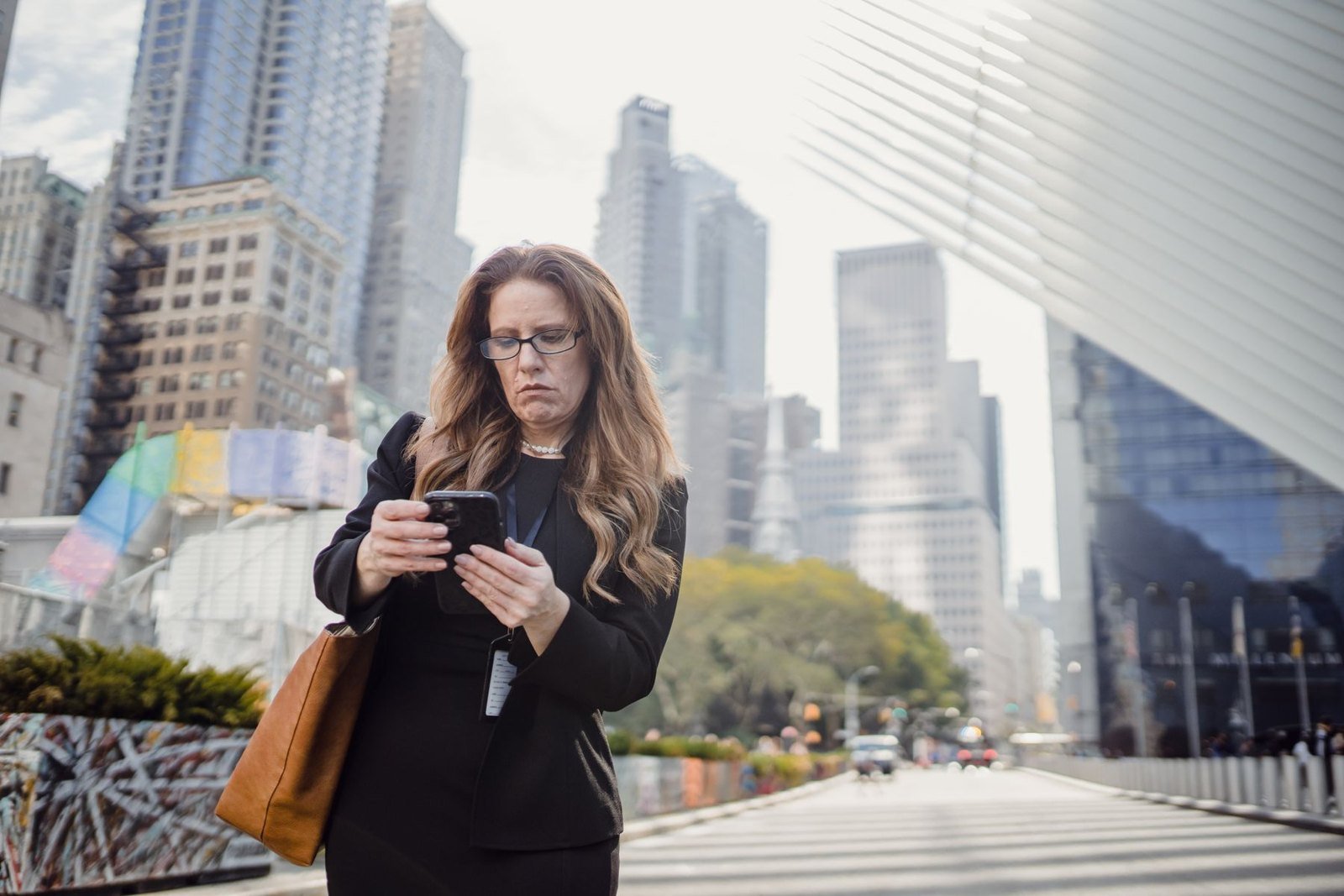 Person using a mobile phone in an urban setting